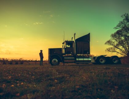 man looking at a truck on the road